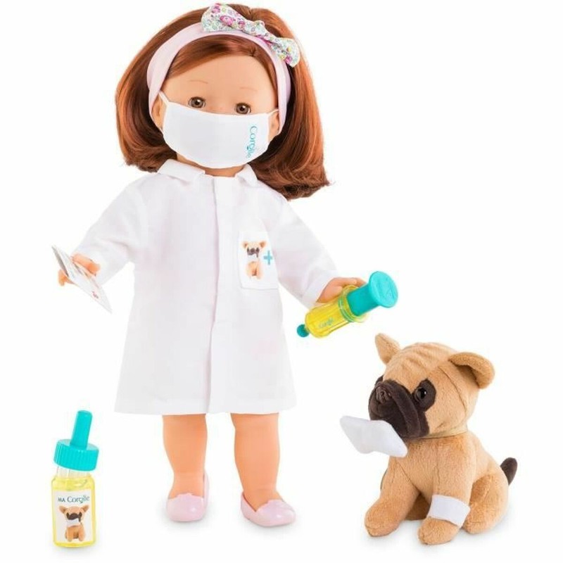 Niña jugando con juego veterinario infantil y muñeca