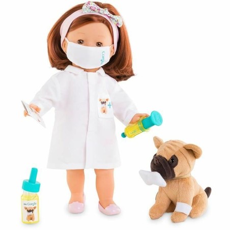 Niña jugando con juego veterinario infantil y muñeca